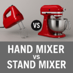 A hand mixer and a stand mixer side by side on a modern kitchen countertop, showing the difference in size and style.